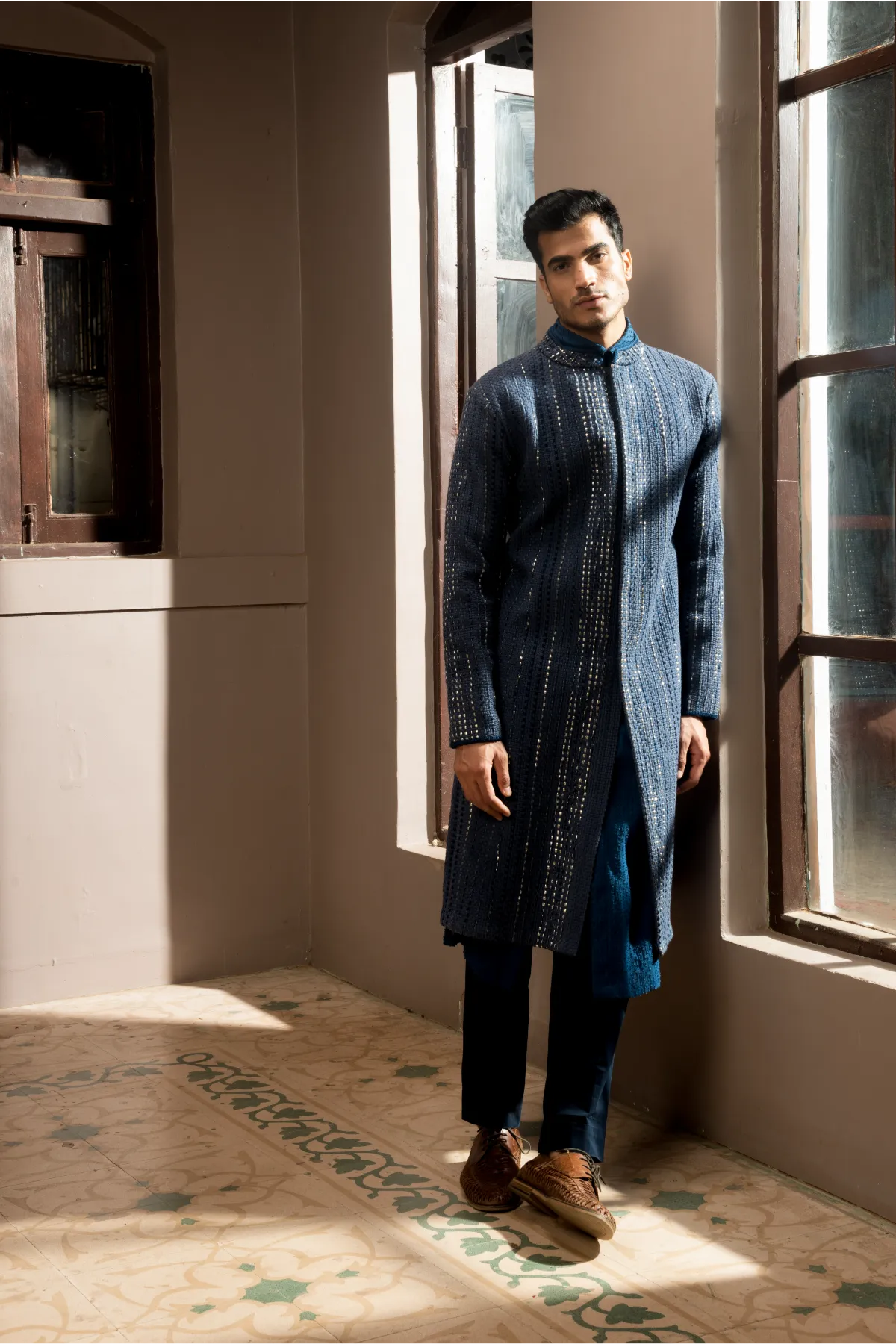 Dark blue textured sherwani with blue long kurta and pleated trousers